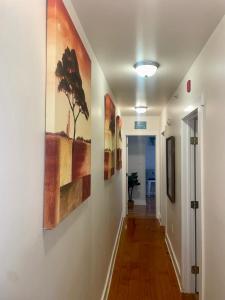 a hallway with paintings on the walls at The Zen Home near Temple U & Drexel FREE STREET PARKING in Philadelphia