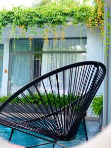 a black bench sitting in front of a building at Sea House Hotels and Apartments in Vung Tau