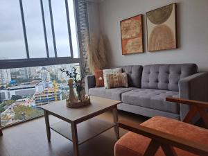 a living room with a couch and a table at Departamento Exclusivo clase A in Lima