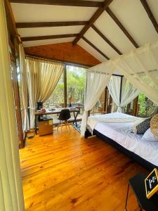 a bedroom with two beds and a desk in it at Hotel La Villa de Victoria Villa de Leyva in Sáchica
