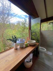 a bathroom with a counter with a window and a toilet at Hotel La Villa de Victoria Villa de Leyva in Sáchica +95 photos
