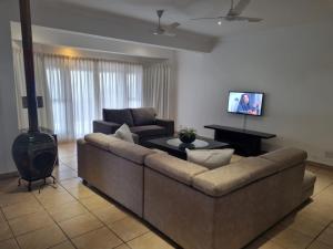 a living room with a couch and a stove at 27 @ Wozani Ridge in Hibberdene