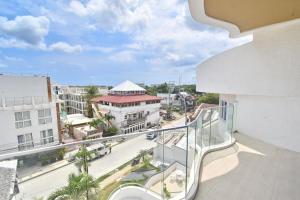 an apartment balcony with a view of a city at Blue Suites Boracay in Boracay