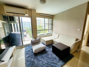 a living room with a white couch and a tv at 2 Bedrooms 2 bath Apartment in Chiang Mai