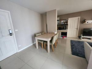 a kitchen with a table and chairs in a room at 2 Bedrooms 2 bath Apartment in Chiang Mai