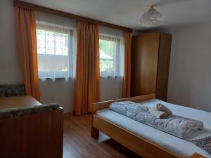 1 dormitorio con 1 cama y 2 ventanas en Unterweg Hof, en Sarentino