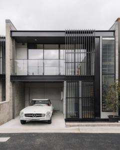 a white car parked in the garage of a house at Stadium View Townhouse in Geelong