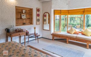 a bedroom with two beds and a window at Lchang Nang Retreat-THE HOUSE OF TREES in Nubra