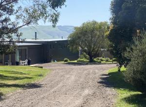 a dirt road in front of a building at Great Ocean Road Wellness and Nature Stay in Apollo Bay