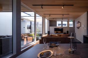 a living room with a table with wine glasses on it at villa vacances hamanako in Hamamatsu