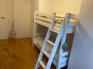 two bunk beds in a room with a ladder at Maria’s place central in Oslo in Oslo