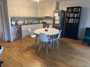 a kitchen with a table and chairs and a refrigerator at Maria’s place central in Oslo in Oslo