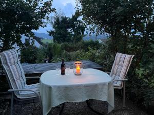 a table with a bottle of wine and a candle on it at Ferienwohnung-Weil-Burg in Weilburg