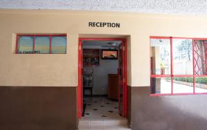 an entrance to a library with a red door at Jupiter Guest Resort - Langata in Nairobi
