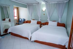 เตียงในห้องที่ Jupiter Guest Resort - Langata