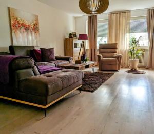 a living room with a couch and a chair at Rastatt Retreat: Zentral und Gemütlich in Rastatt