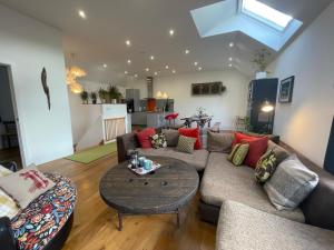 a living room with a couch and a table at 1 Woodlands in Llandysul