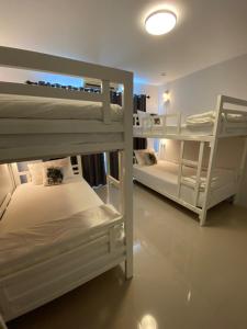 a room with two bunk beds in a room at Khaolak Mind Home Hostel in Khao Lak
