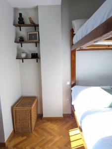 a bedroom with two bunk beds and a wooden floor at Piso Grande La Viña in Biescas