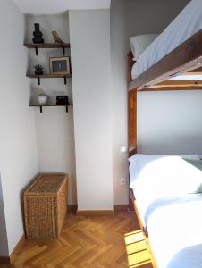 a bedroom with two bunk beds and a wooden floor at Piso Grande La Viña in Biescas