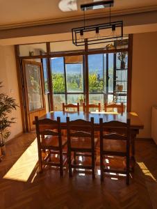 a dining room with a table and chairs with a view at Piso Grande La Viña in Biescas