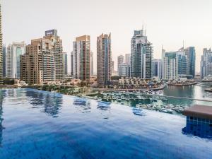 a swimming pool with a view of a city at Maison Privee - Modern Luxury Apt with Spectacular Dubai Marina Vws in Dubai
