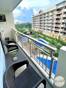 a balcony with a view of a swimming pool at Homestay by ViJiTa 2bedroom condo in Manila