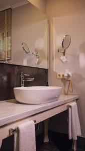 a bathroom with a white sink and a mirror at Villa Lukka in Cıralı +37 photos