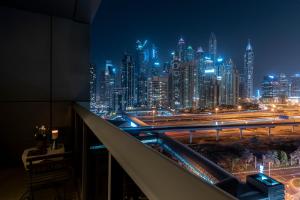 a view of a city skyline at night at BEAUTIFUL HUGE 2 BED ROOM APARTMENT in Dubai