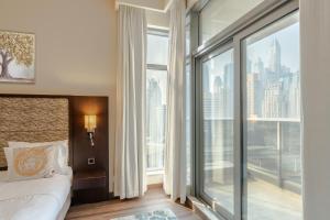 a bedroom with a bed and a large window at BEAUTIFUL HUGE 2 BED ROOM APARTMENT in Dubai