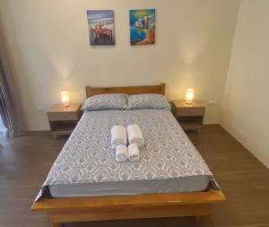 sypialnia z łóżkiem z dwoma białymi ręcznikami w obiekcie Lucia’s Place w mieście Tanauan