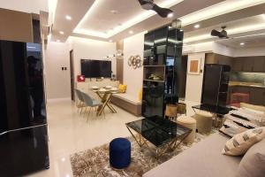 a living room with a couch and a table at Stylish 2 Bedroom Condo Near BGC and Airport with Fast WiFi in Manila