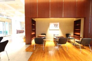 a waiting room with chairs and tables in a building at KOKO HOTEL Sendai Station West in Sendai