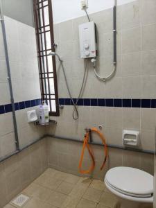 a bathroom with a toilet and a shower in it at June's Homestay@ Puteri Wangsa near Aeon & IKEA in Ulu Tiram
