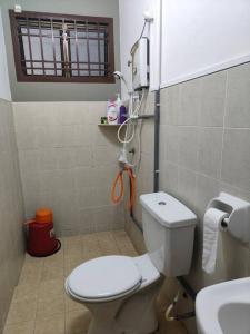 a small bathroom with a toilet and a sink at June's Homestay@ Puteri Wangsa near Aeon & IKEA in Ulu Tiram