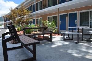 a group of benches sitting outside of a building at The Angler Lodge in Dunsmuir