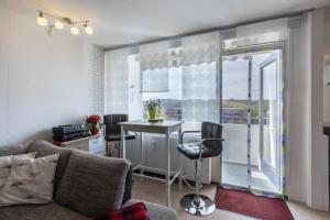 Una sala de estar con una mesa y sillas y una ventana. en Harzblick, en Altenau