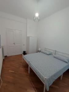 ein Schlafzimmer mit einem Bett in einem weißen Zimmer in der Unterkunft Lucia appartamento uso esclusivo - Aeroporto Genova Sestri Ponente in Genua