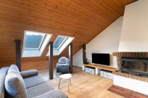 a living room with a couch and a fireplace at Ferienhaus Schwarzwaldleben in Seebach