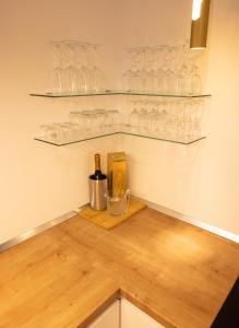a kitchen with glasses and a bottle of wine at Stay & Heal Apartman in Rogaška Slatina