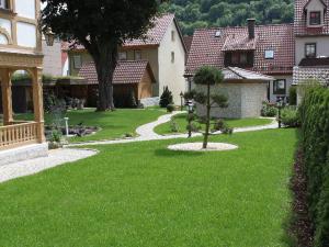 einen Garten mit grünem Rasen und einem Baum in der Unterkunft Ferienhaus Villa Marina in Bad Urach