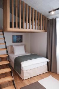 a bedroom with a bunk bed with a ladder at Casa Flurina in Flims