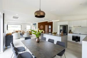 a kitchen and living room with a table and chairs at The Otium at Caversham House in Caversham