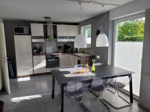 a kitchen with a black table and some chairs at Ferienhaus Gammendorf in Gammendorf