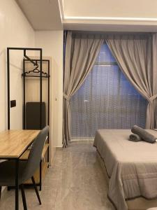 a bedroom with a bed and a table and a window at Home Sweet Home 2 rooms Apartment in Melaka