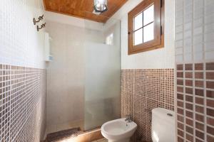 a bathroom with a toilet and a sink and a window at Casa Rural Medina 1 in Agulo +22 photos