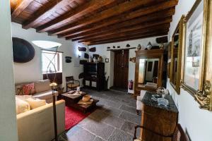 a living room with a couch and a table at Ancient Historical House in Santa Lucía