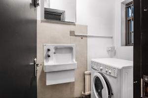 a bathroom with a washer and dryer in it at Circlelet Luxury Private Suite 1 in London