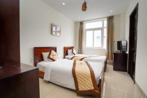 Ένα ή περισσότερα κρεβάτια σε δωμάτιο στο Sunview Beach Hotel Danang