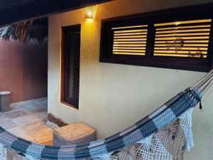 una hamaca fuera de una casa con un edificio en The Barra Grande Guesthouse & Hostel, en Barra Grande